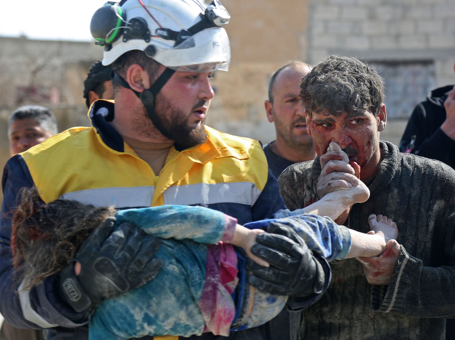 A Syrian man kisses the feet of his daughter who was killed following reported shelling in the town of Khan Sheikhoun on February 26, 2019.
