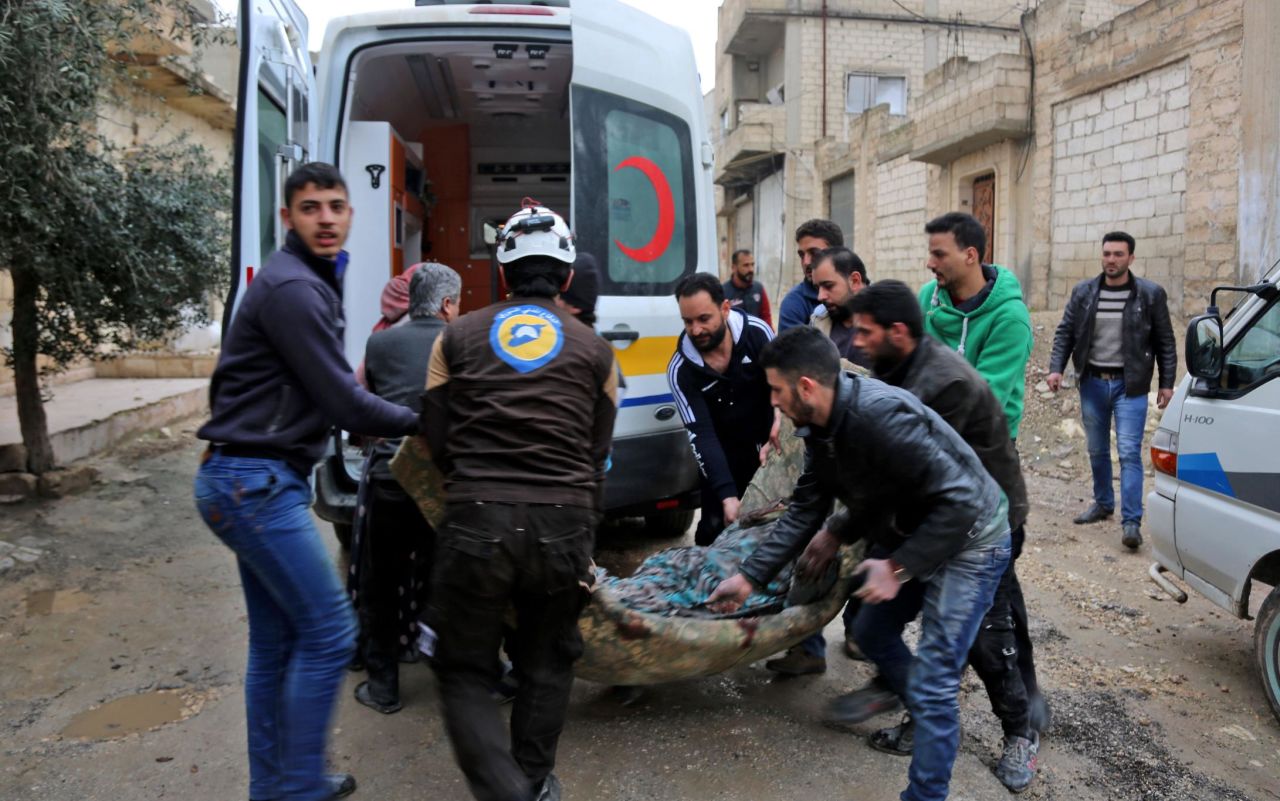 A member of the Syrian Civil Defense -- also known as The White Helmets -- carries a wounded woman following a strike in the town of Khan Sheikhoun on February 15, 2019. Kutini added that "Anas witnessed many massacres. He was injured during the chemical attack that targeted Khan Sheikhoun, he was also injured in another barrel bomb attack while covering the civil defense efforts to rescue civilians. But today, Assad and his allies got him."