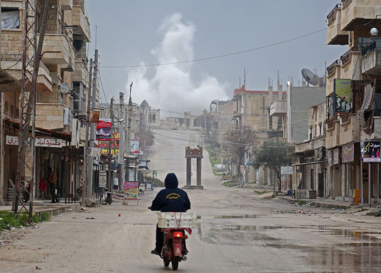 A man rides a scooter on a street during reported air strikes in the town of Khan Sheikhoun in the southern countryside of the rebel-held Idlib province on February 22, 2019. "Anas will be always remembered as the one who chose to stay behind the scenes and fight with his camera," the White Helmets said in a statement.