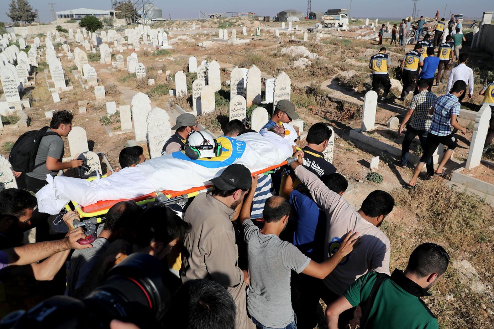 Members of the Syrian Civil Defense and friends carry the body of citizen journalist Anas al-Dyab during his funeral in Idlib, Syria, on July 21.