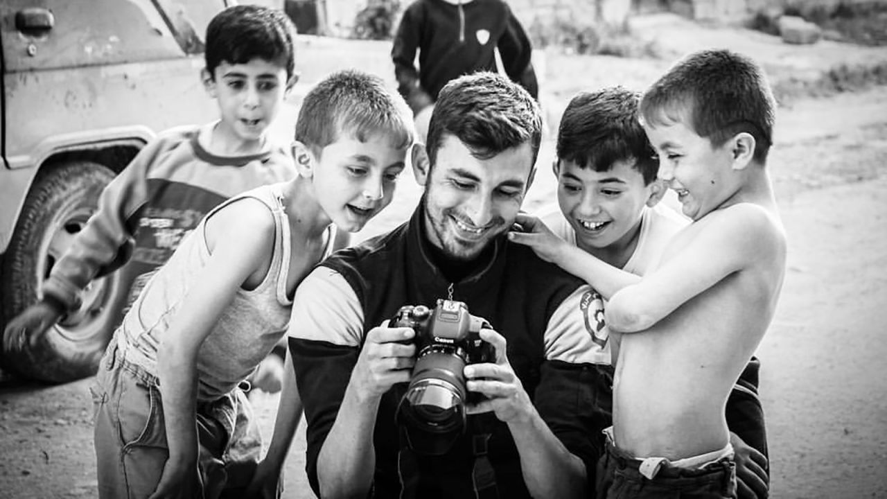Anas al-Dyab shows young children photos from his camera. Al-Dyab was killed Sunday, July 21, 2019, following heavy bombardment in Khan Sheikhun, in Idlib, Syria.