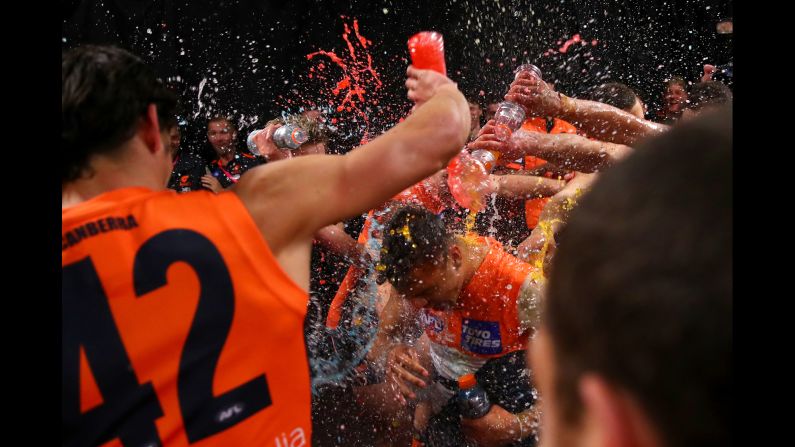 Bobby Hill of the Greater Western Sydney Giants celebrates with teammates in their lockeroom after winning the Round 18 AFL match against the Collingwood Magpies in Sydney, Australia, on Saturday, July 20.