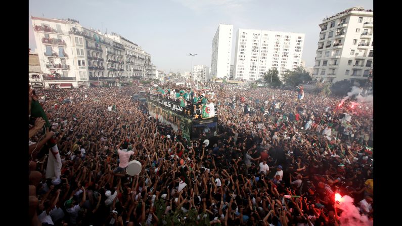 The Algerian soccer team travels on a bus through a crowd of fans during a parade in celebration of the team's Africa Cup of Nations victory in Algiers, Algeria, on Saturday, July 20.