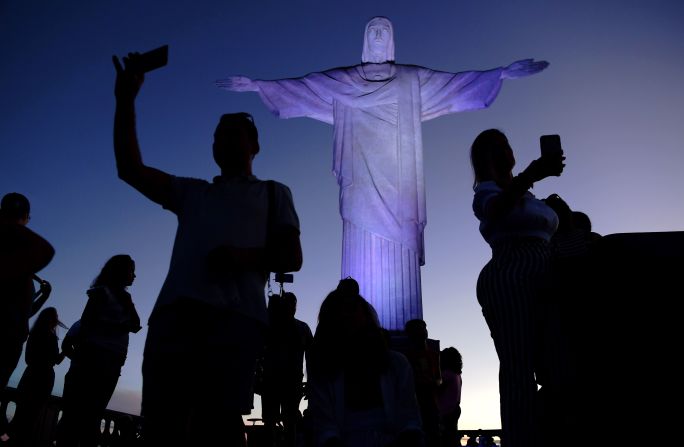 <strong>Christ the Redeemer (Brazil):</strong> Inspired tourists take selfies by the Christ the Redeemer statue. The site also has jaw-dropping views of Rio de Janeiro and the gorgeous Brazilian coast.