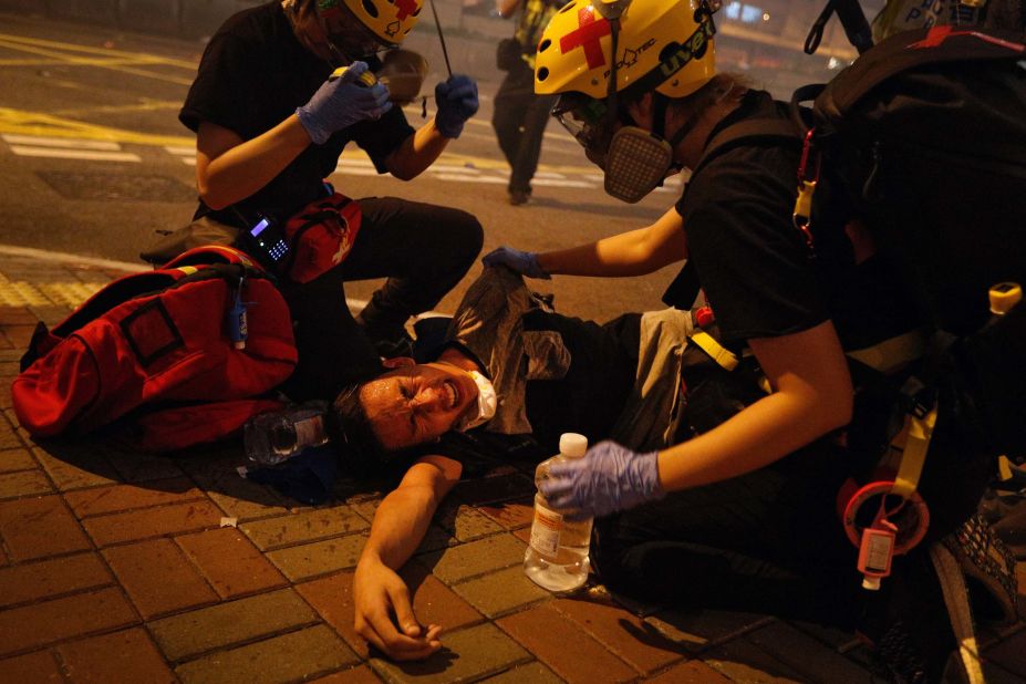 Medical workers help a protester affected by tear gas on July 21.