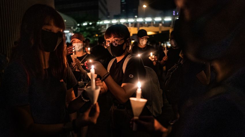 Mourners hold candles during a candlelight vigil to commemorate a protestor who died last night during a rally against a controversial extradition law proposal on June 17, 2019 in Hong Kong, China.