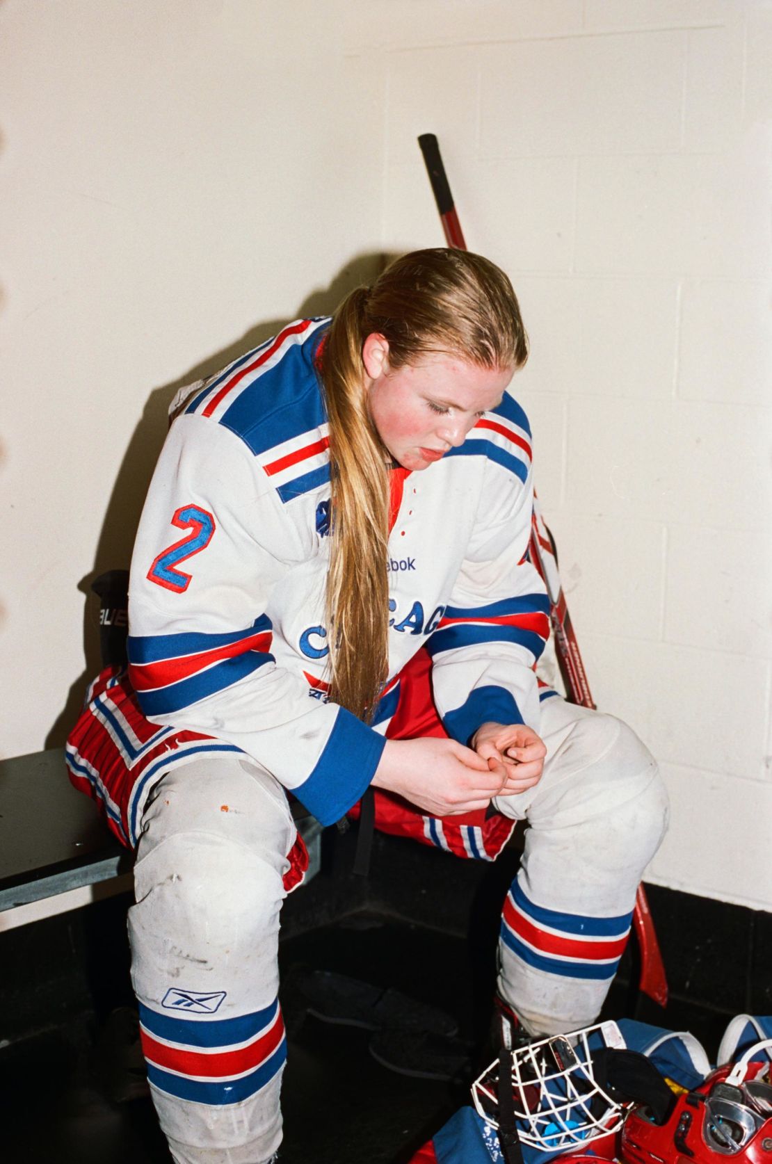 The bright colors and stark white of hockey players' uniforms, combined with Paterson's choice to shoot on film and use bright flash, produce an aesthetic that mimics the sports photography of the 80s. 