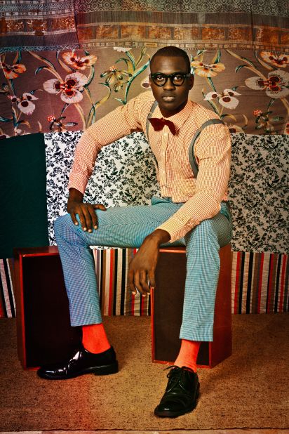 Thierno Ndiaye seated for a 2012 portrait by Omar Victor Diop from the series Le Studio des Vanités.