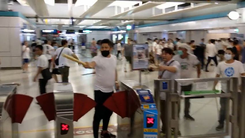 A mob attacks commuters in Hong Kong.