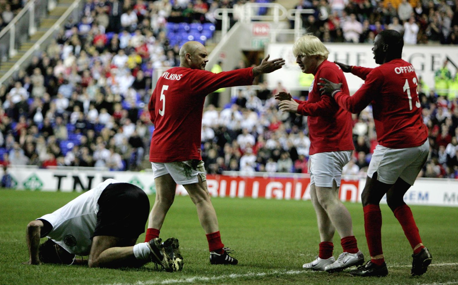 Johnson looks apologetic after fouling Germany's Maurizio Gaudino during a charity soccer match in Reading, England, in May 2006.