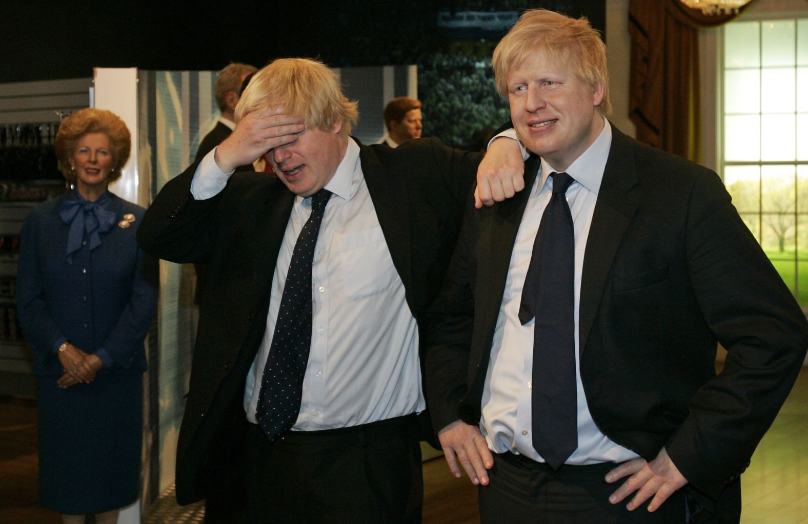 Johnson, left, poses with a wax figure of himself at Madame Tussauds in London in May 2009.