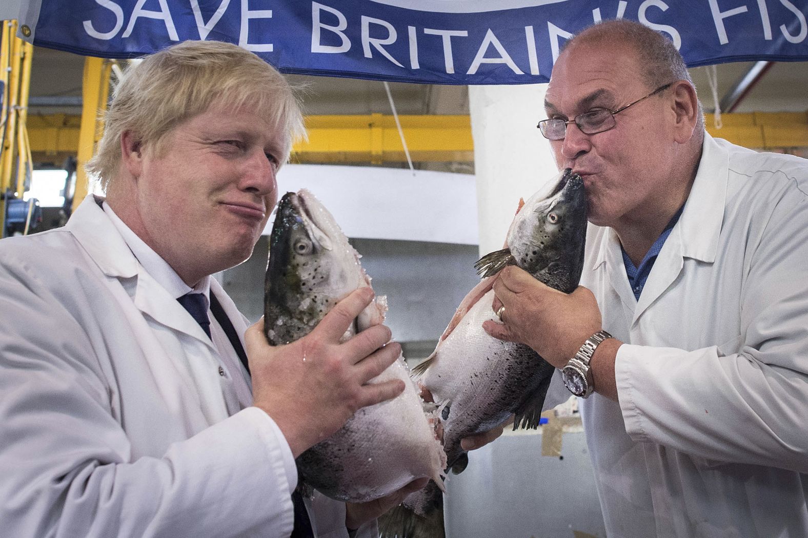 Johnson kisses a wild salmon while visiting a fish market in London in June 2016. A month earlier, he stepped down as mayor but remained a member of Parliament for Uxbridge and South Ruislip.