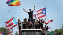 SAN JUAN, PUERTO RICO - JULY 22: Singer Ricky Martin waves a flag as he joins with thousands of other people as they fill the Expreso Las Américas highway calling for the ouster of Gov. Ricardo A. Rosselló on July 22, 2019 in San Juan, Puerto Rico. The protesters are calling on Gov. Rosselló to step down after a group chat was exposed that included misogynistic and homophobic comments. (Photo by Joe Raedle/Getty Images)