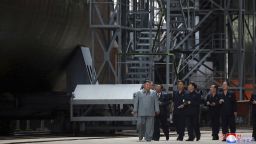 North Korean leader Kim Jong Un is seen standing beside a submarine under construction in this photograph released by North Korean state media Tuesday. 