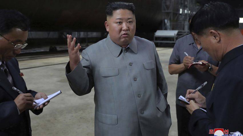 In this undated photo provided on Tuesday, July 23, 2019, by the North Korean government, North Korean leader Kim Jong Un, center, speaks while inspecting a newly built submarine to be deployed soon, at an unknown location in North Korea. North Korean state media's report on Tuesday comes days after North Korea said it may lift its 20-month suspension of nuclear and missile tests to protest expected military drills between the United States and South Korea. Independent journalists were not given access to cover the event depicted in this image distributed by the North Korean government. The content of this image is as provided and cannot be independently verified. Korean language watermark on image as provided by source reads: "KCNA" which is the abbreviation for Korean Central News Agency. (Korean Central News Agency/Korea News Service via AP)