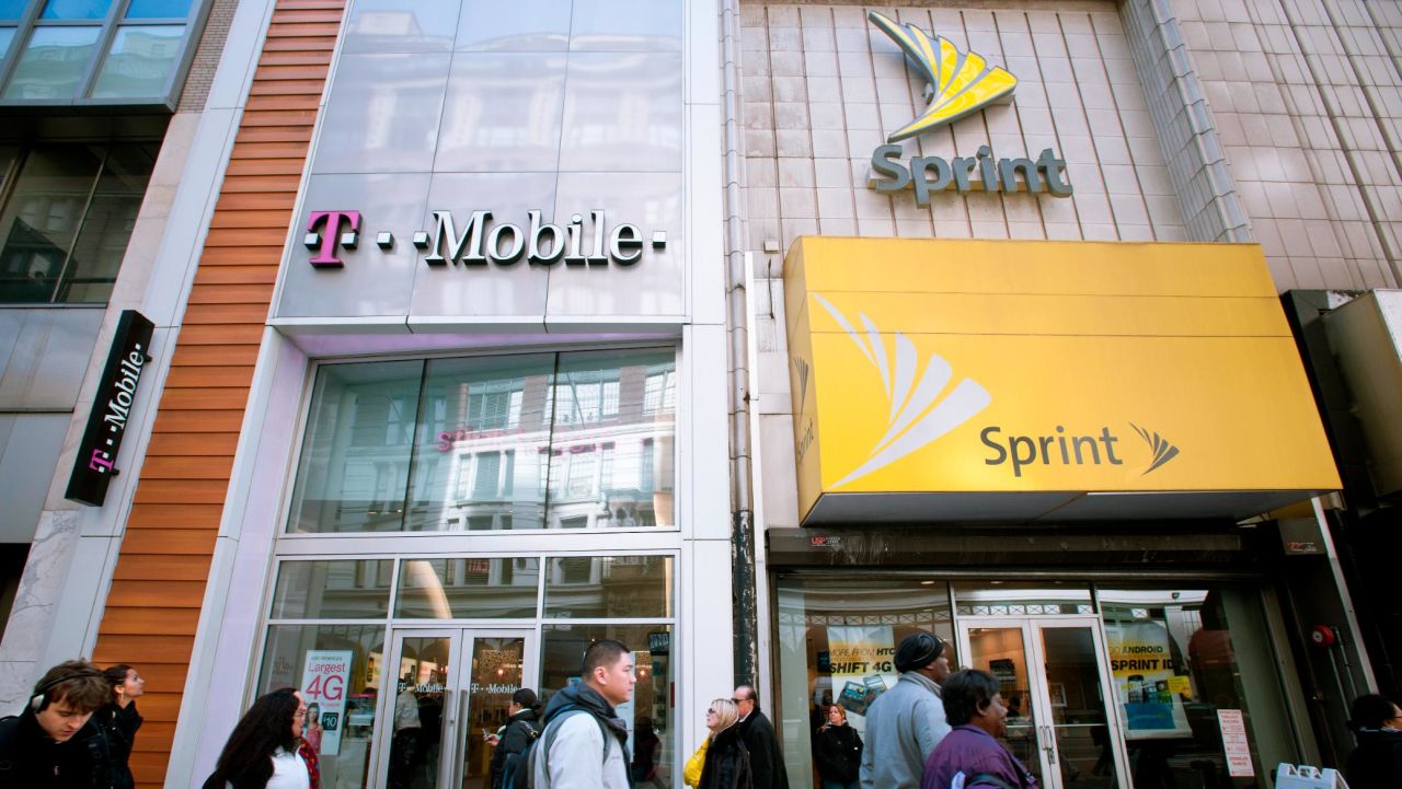 T-Mobile and Sprint Nextel cellular phone stores adjoin each other in Herald Square in New York on Tuesday, March 8, 2011. Sprint announced ti is cutting 2500 jobs, approximately 7 percent of its workers, and closing call centers in a $2.5 billion cost cutting endeavor. (Photo by Richard Levine/Corbis via Getty Images)