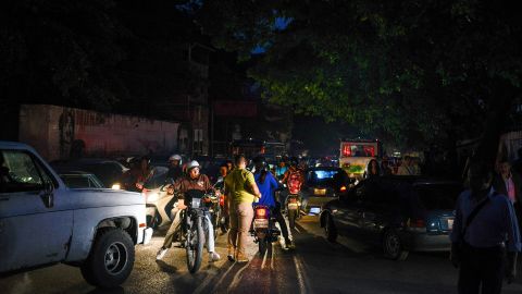 People on cars, motorbikes and on foot crowd in Caracas after Venezuela was hit by a massive power cut on July 22, 2019.