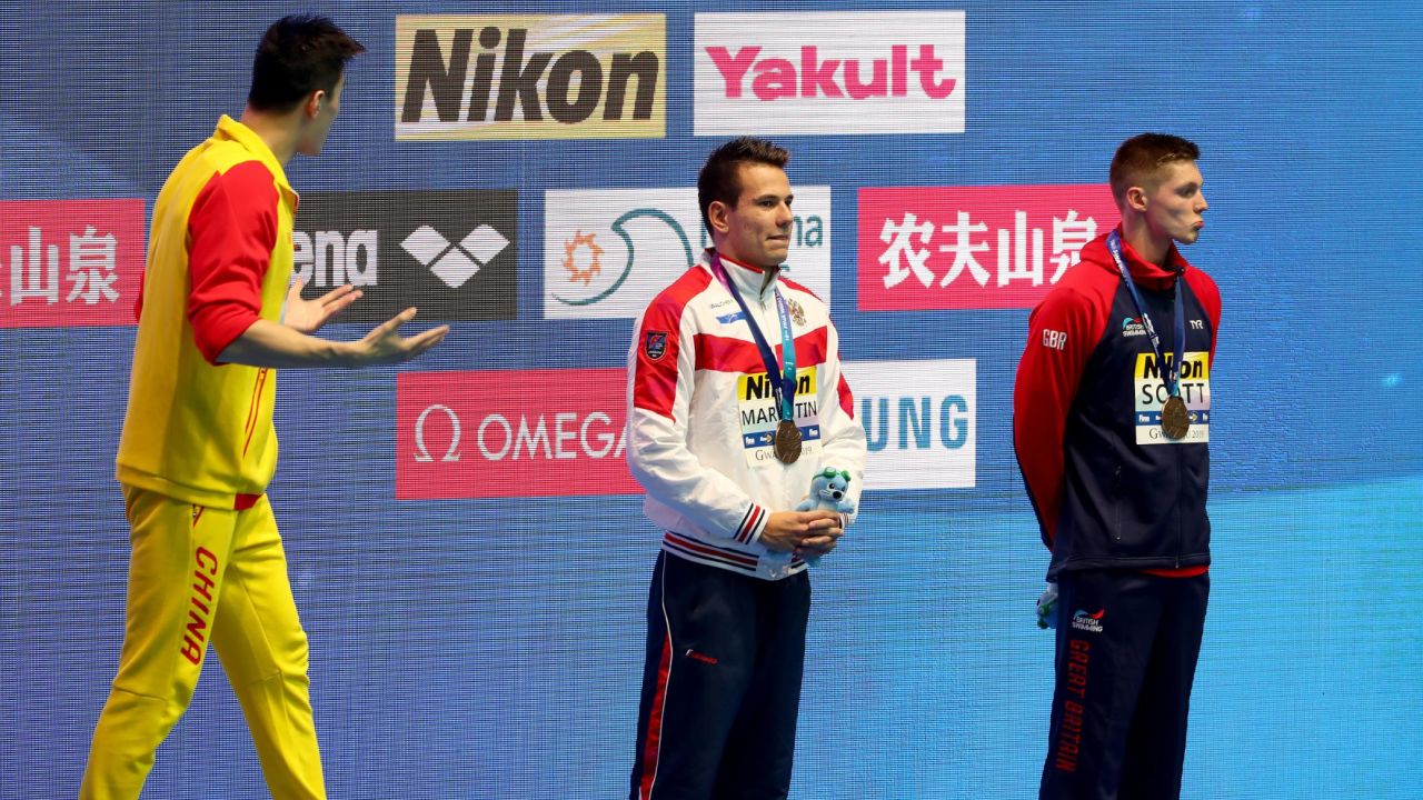 Gold medalist Sun Yang of China (left) and bronze medalist Duncan Scott of Great Britain (right) interact during the medal ceremony for the Men's 200m Freestyle Final.