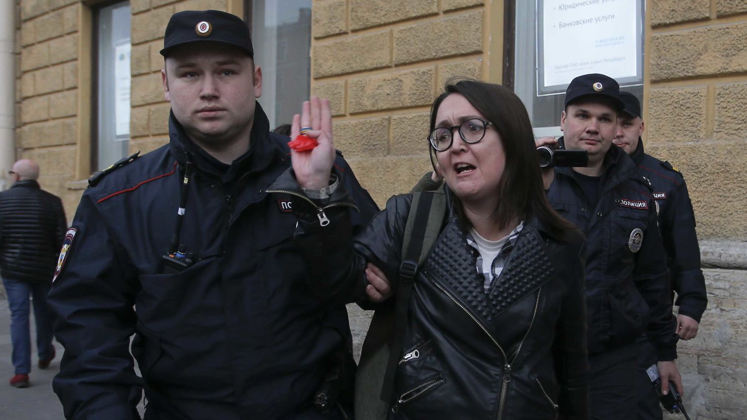 Police officers detain Yelena Grigoryeva during a rally held by LGBTQ activists in St. Petersburg in April.