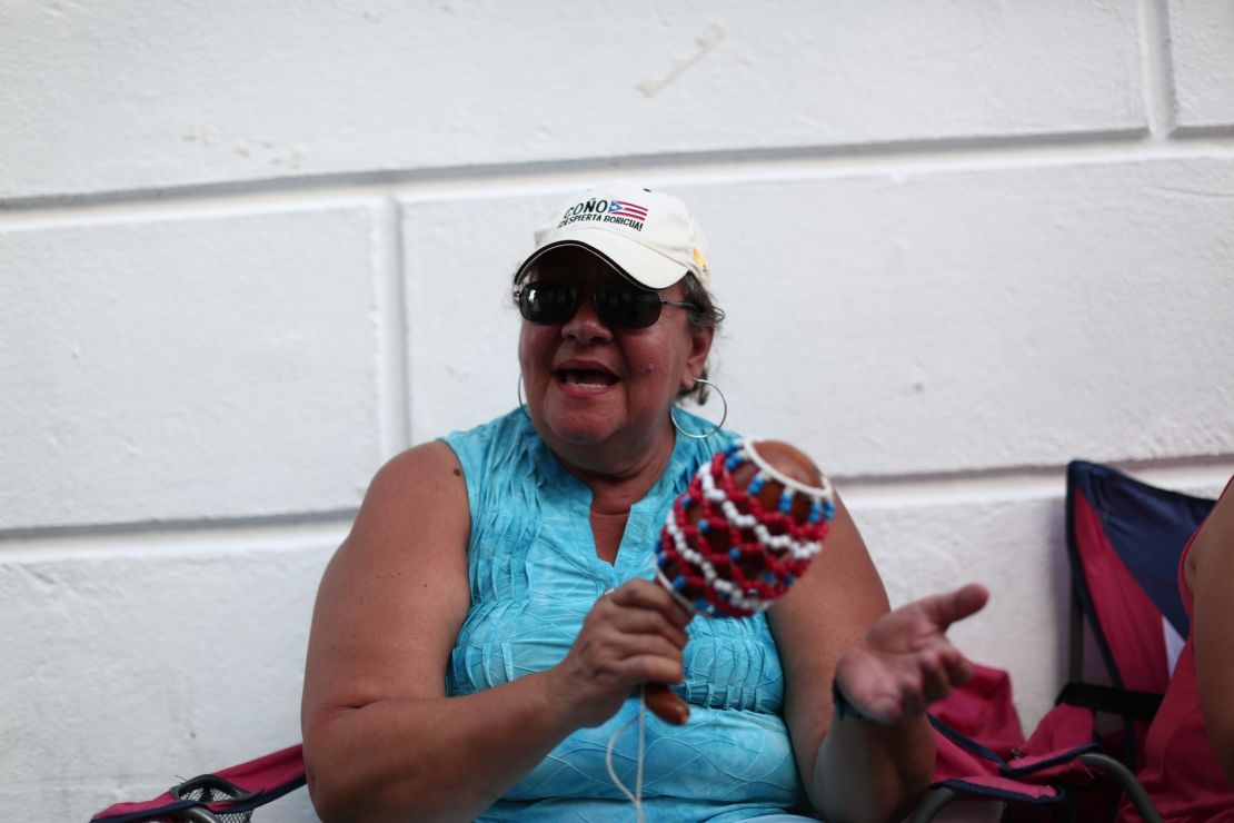 Elba Nazario, a retired teacher, protests near the governor's mansion.