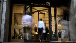 People enter the Deutsche Bank AG headquarters at 60 Wall Street in New York, U.S., on Monday, July 8, 2019. A total of 18,000 jobs are due to be cut as Deutsche Bank exits the equities business in a 7.4 billion-euro ($8.3 billion) restructuring intended to turn around years of decline. Photographer: Michael Nagle/Bloomberg via Getty Images