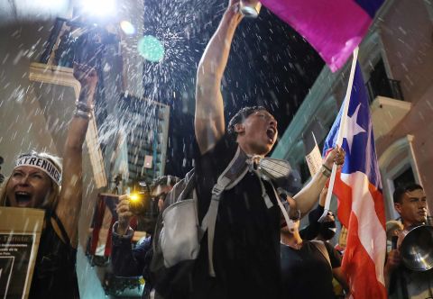 Demonstrators react Tuesday, July 23, upon hearing reports that Rosselló would step down.