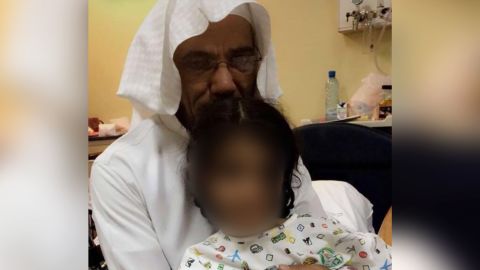 Awda and his daughter, whose face has been blurred.