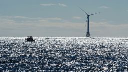 A boat passes one of the wind turbines of the Block Island Wind Farm on October 14, 2016 off the shores of Block Island, Rhode Island.
The first offshore wind project in America has created more than 300 construction jobs and will deliver the electricity demands for the entire island.  / AFP / DON EMMERT        (Photo credit should read DON EMMERT/AFP/Getty Images)