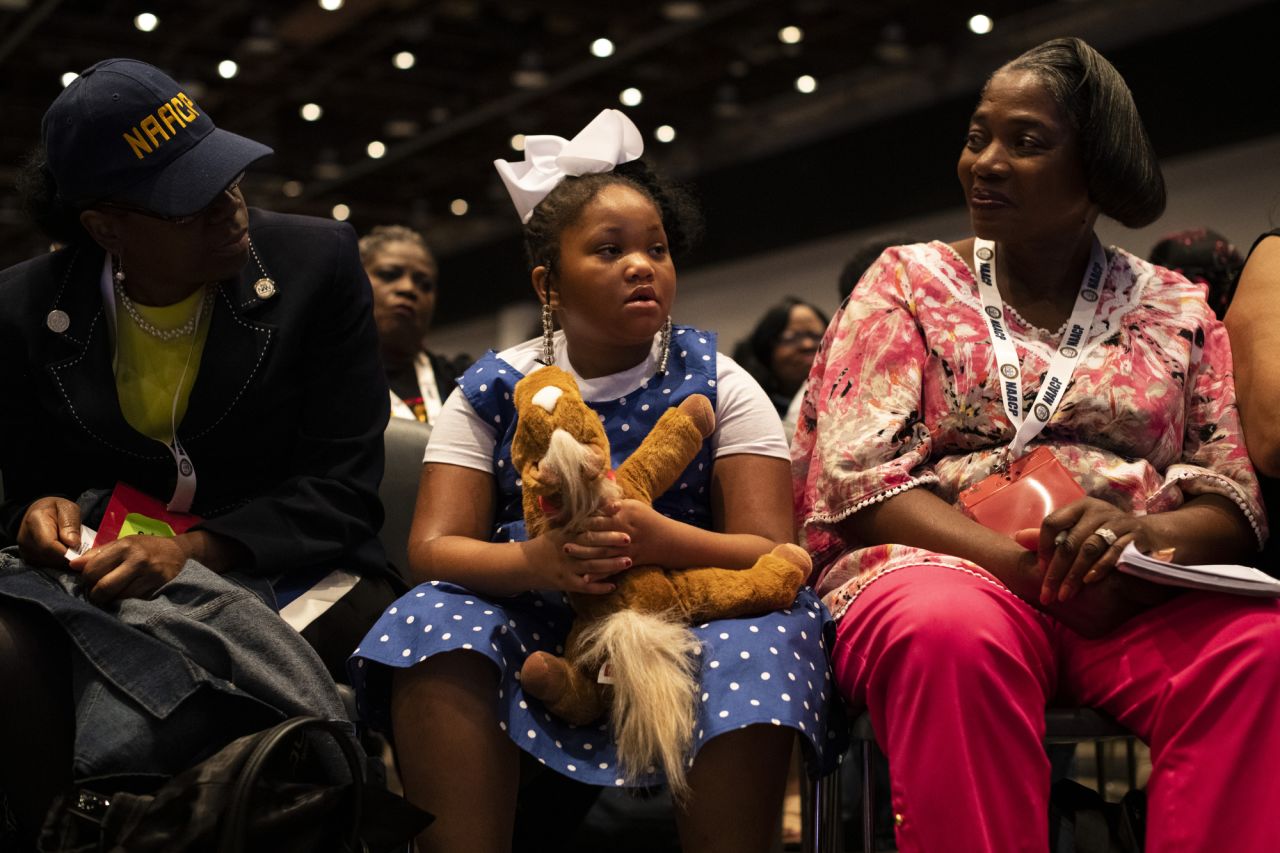 Maddison Griffin, a 7-year-old from Cleveland, listens to opening remarks.