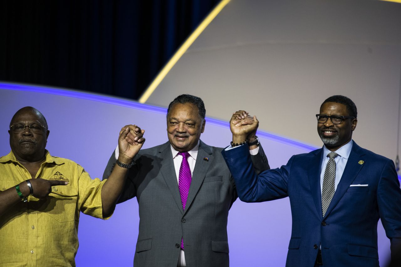 Civil rights leader Jesse Jackson, center, joins hands with Detroit NAACP President Wendell Anthony, left, and National NAACP President and CEO Derrick Johnson before the start of the forum.