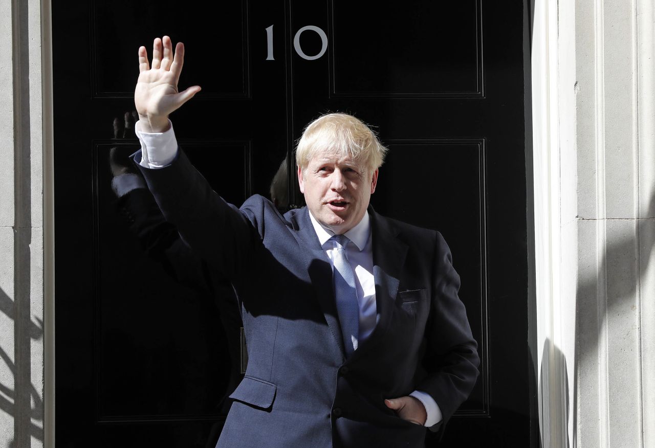 Boris Johnson waves from the steps of No. 10 Downing Street after giving a statement in London in July 2019. He had just become prime minister.
