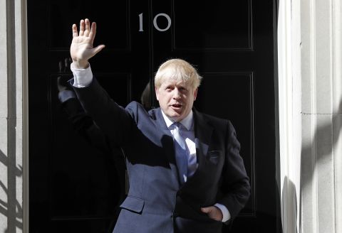 British Prime Minister Boris Johnson waves from the steps of No. 10 Downing Street after giving a statement in London in July 2019. He had just become prime minister.