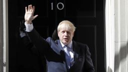 Britain's new Prime Minister Boris Johnson waves from the steps outside 10 Downing Street, London, on July 24, 2019.