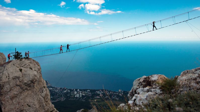 <strong>Yalta, Crimean Mountains: </strong>Brave souls cross a hanging bridge linking the two peaks of Ai-Petri Mountain, famously one of the windiest places in the region. 