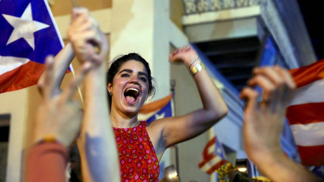 A woman celebrates near La Fortaleza.