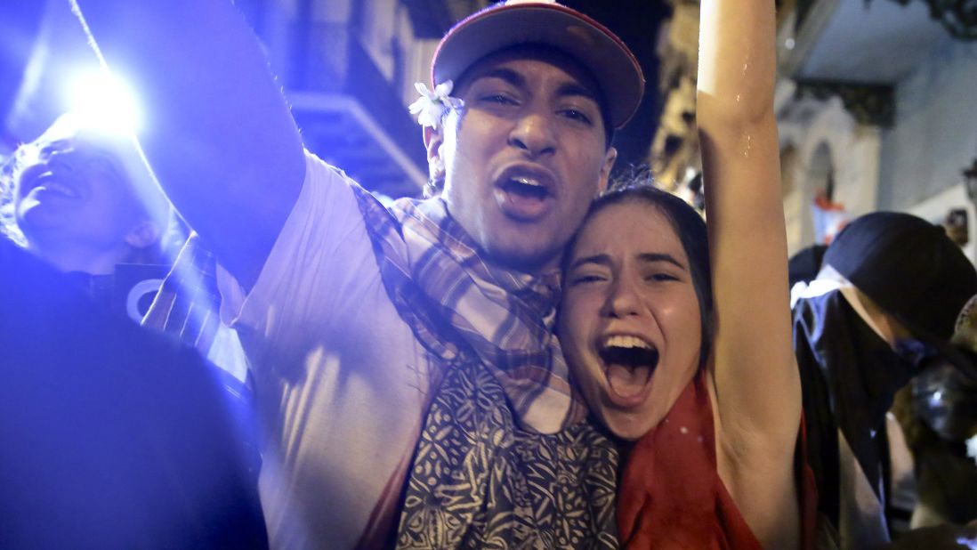 Demonstrators react in front of the governor's mansion, known as La Fortaleza.