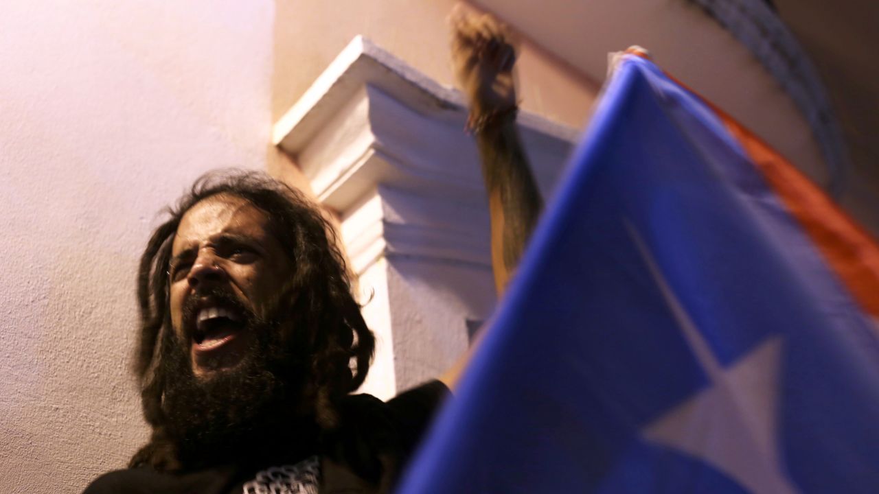 A Puerto Rican man cheers after the resignation of Rosselló.