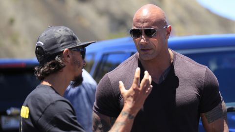 Actor Dwayne "The Rock" Johnson, right, talks with TMT opposition leader Kaho'okahi Kanuha during a visit to the protests against the TMT telescope, Wednesday, July 24, 2019, at the base of Mauna Kea on Hawaii Island. (Jamm Aquino/Honolulu Star-Advertiser via AP)
