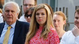 Carrie Symonds (C), girlfriend of Britain's new Prime Minister Boris Johnson, waits for the prime minister's arrival with members of staff in Downing Street in London on July 24, 2019 on the day he was formally appointed British prime minister. - Boris Johnson takes charge as Britain's prime minister on Wednesday, on a mission to deliver Brexit by October 31 with or without a deal. (Photo by Tolga AKMEN / AFP)        (Photo credit should read TOLGA AKMEN/AFP/Getty Images)