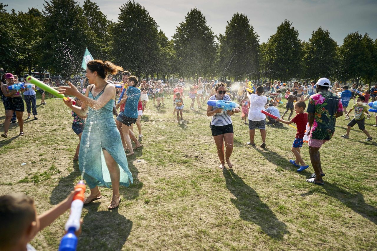 People cool off with a water fight at a park in The Hague, Netherlands, on Wednesday, July 24.