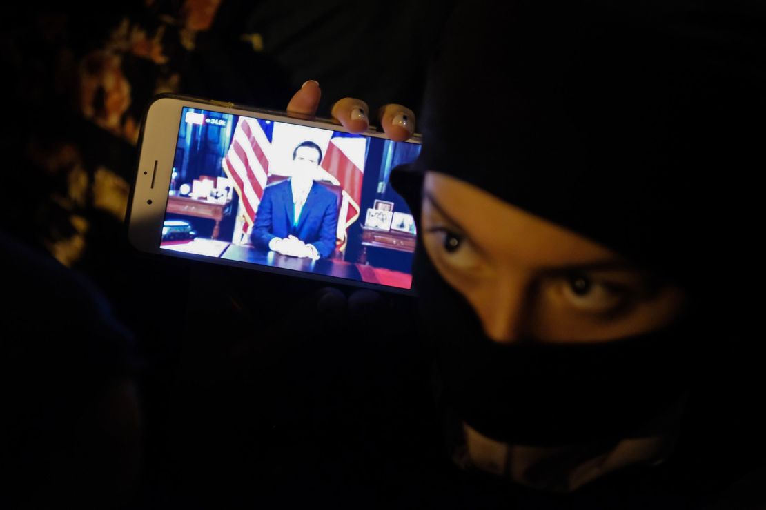 Protesters in the streets of Old San Juan were watching the governor's message on their phones.