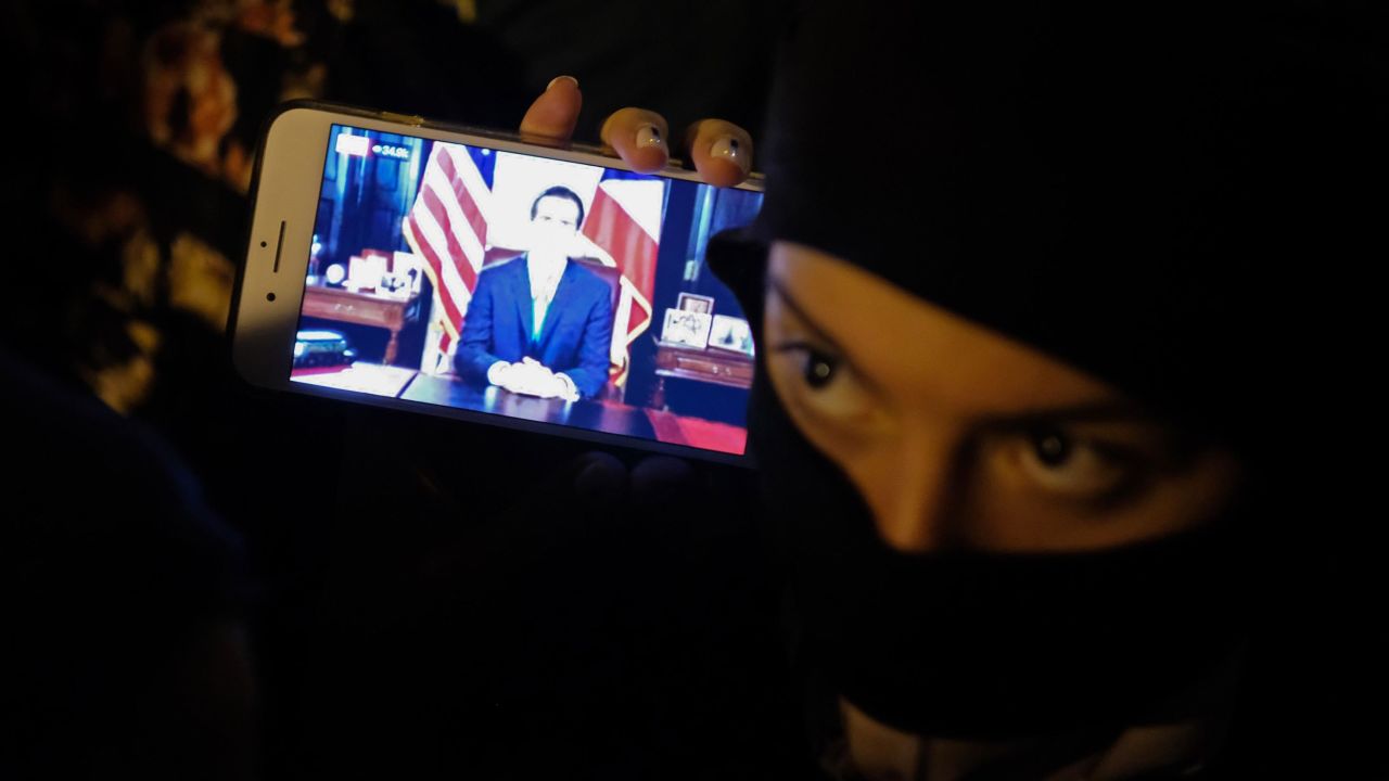 Protesters in the streets of Old San Juan were watching the governor's message on their phones.