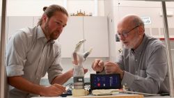 University of Utah biomedical engineering doctoral student Jacob George, left, and associate professor Gregory Clark, are helping develop a prosthetic arm that can move via the wearer's thoughts as well as feel the sensation of touch to make it easier to pick up and hold objects.