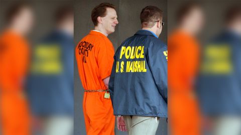 Dustin Honken is led by US marshals from the federal building in Sioux City, Iowa, on October 27, 2004. 