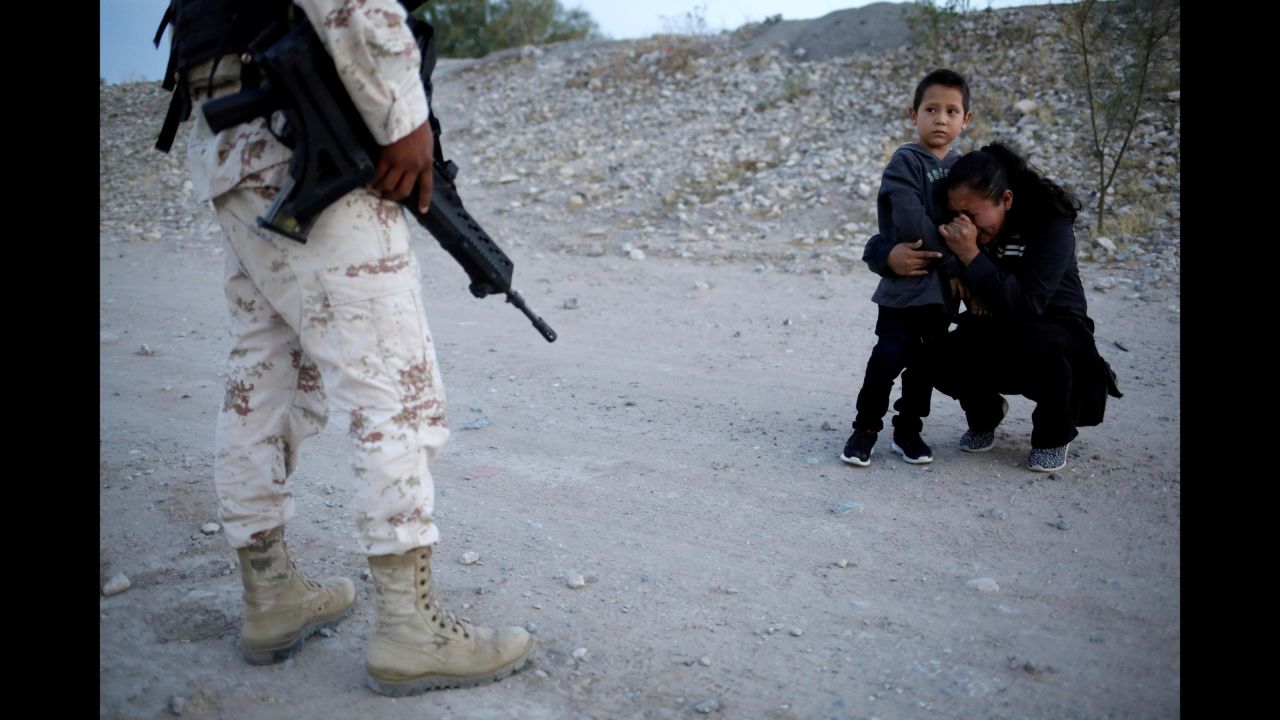 Guatemalan migrant Lety Perez embraces her son Anthony while asking a member of the Mexican National Guard to let them cross into the United States on Monday, July 22. <a href="https://www.cnn.com/2019/07/26/us/migrant-child-photo-trnd/index.html" target="_blank">Q&A: Reuters photographer Jose Luis Gonzalez describes the scene he witnessed</a>