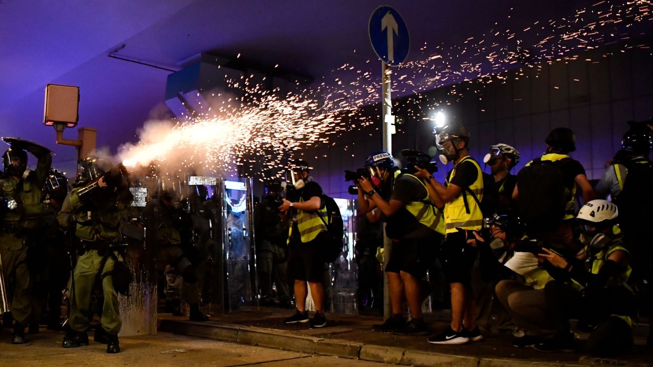 A police officer fires tear gas to disperse protesters in Hong Kong on Sunday, July 21. <a href="https://www.cnn.com/2019/07/21/asia/hong-kong-protest-july-21-intl-hnk/index.html" target="_blank">Tens of thousands took to the streets for the seventh consecutive weekend</a> to protest a now-suspended extradition bill.