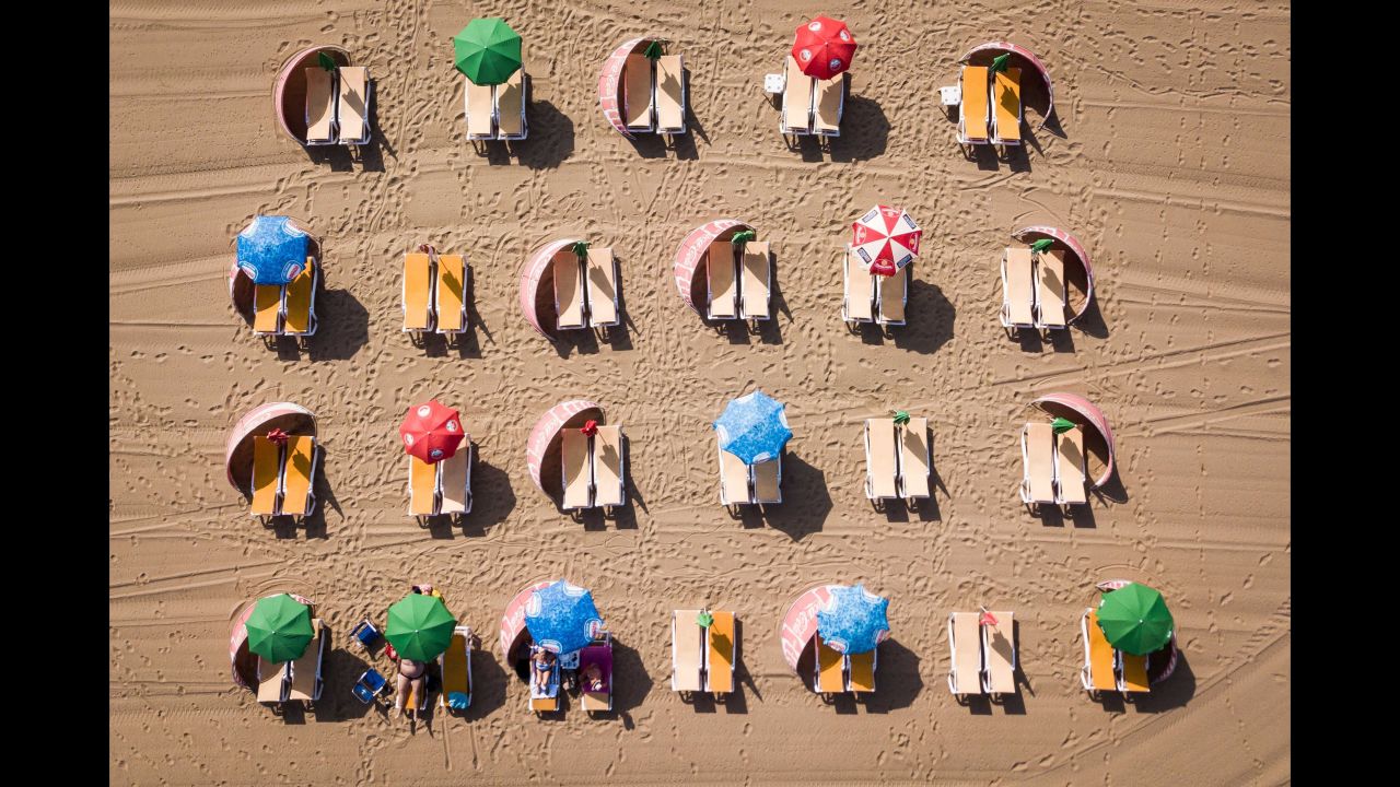 This aerial image shows beach umbrellas and deck chairs in Scheveningen, Netherlands, on Wednesday, July 24. The Netherlands is among the European countries that have experienced <a href="https://www.cnn.com/2019/07/25/europe/gallery/europe-heat-wave/index.html" target="_blank">record-breaking temperatures this summer.</a>