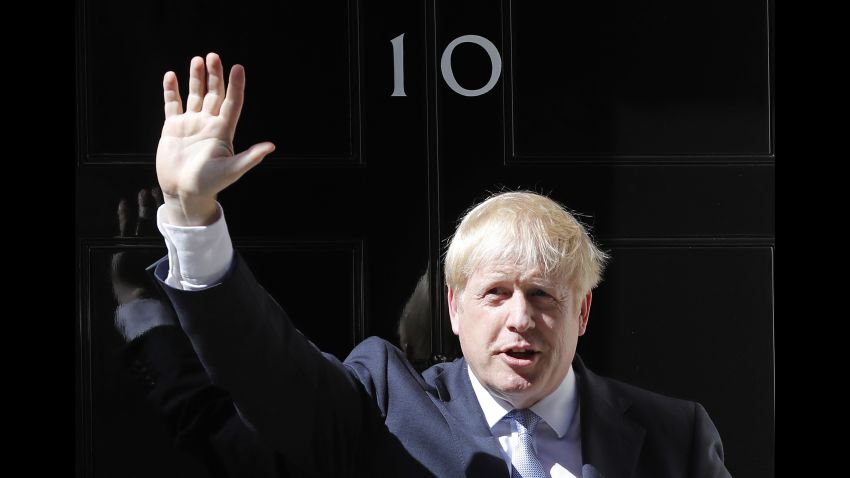 Britain's new Prime Minister Boris Johnson waves from the steps outside 10 Downing Street, London, Wednesday, July 24, 2019. Boris Johnson has replaced Theresa May as Prime Minister, following her resignation last month after Parliament repeatedly rejected the Brexit withdrawal agreement she struck with the European Union. (AP Photo/Frank Augstein)