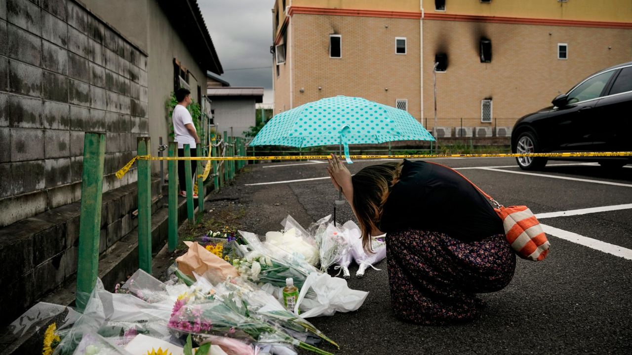 A woman prays Friday, July 19, at a makeshift memorial honoring the victims of a fire in Kyoto, Japan. <a href="https://www.cnn.com/2019/07/24/us/crowdfunding-campaign-for-kyoto-arson-victms-trnd/index.html" target="_blank">A suspected arson attack</a> killed 34 people at the Kyoto Animation Studio. It is being described as the country's worst mass killing in almost 20 years.