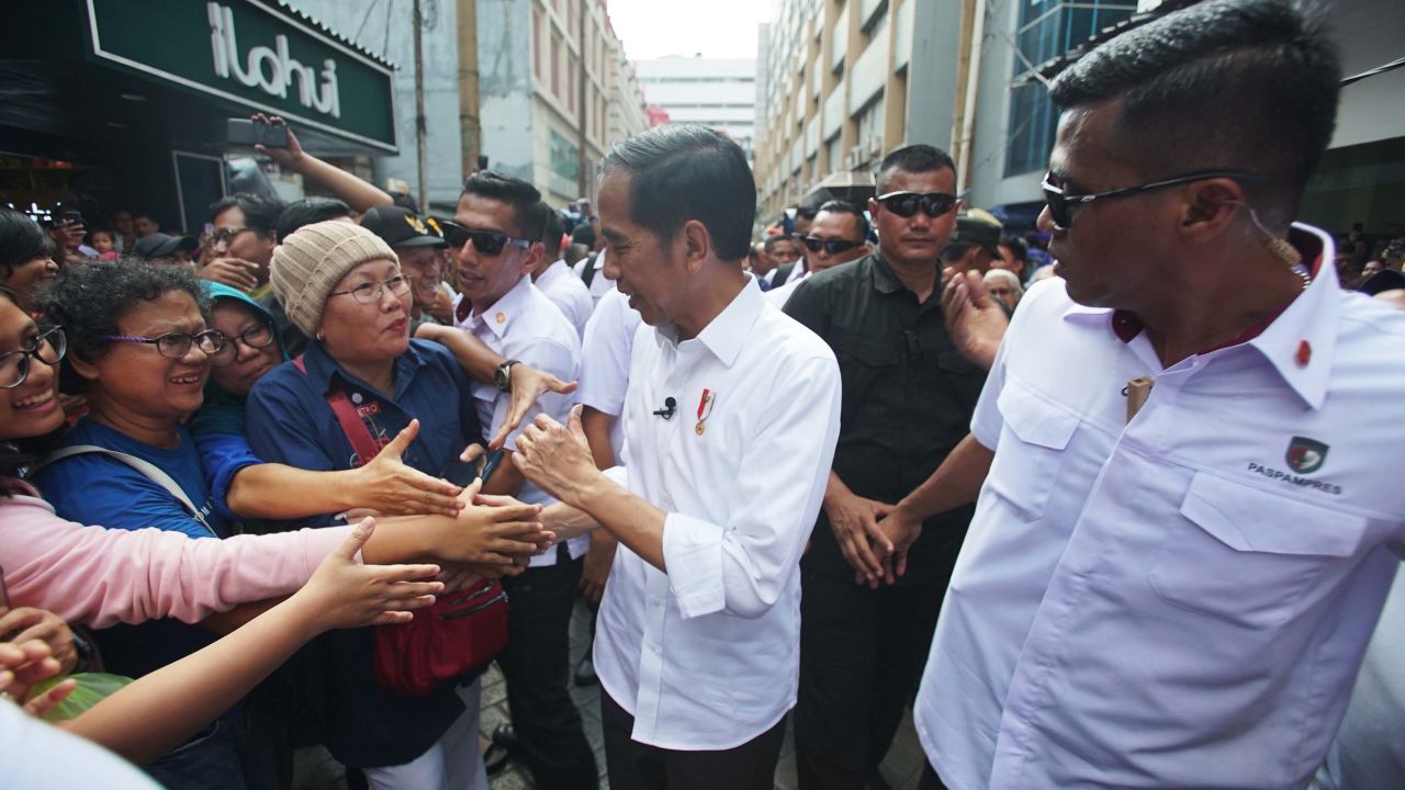 Indonesian President Joko Widodo greets people at the Pasar Baroe shopping center in central Jakarta.